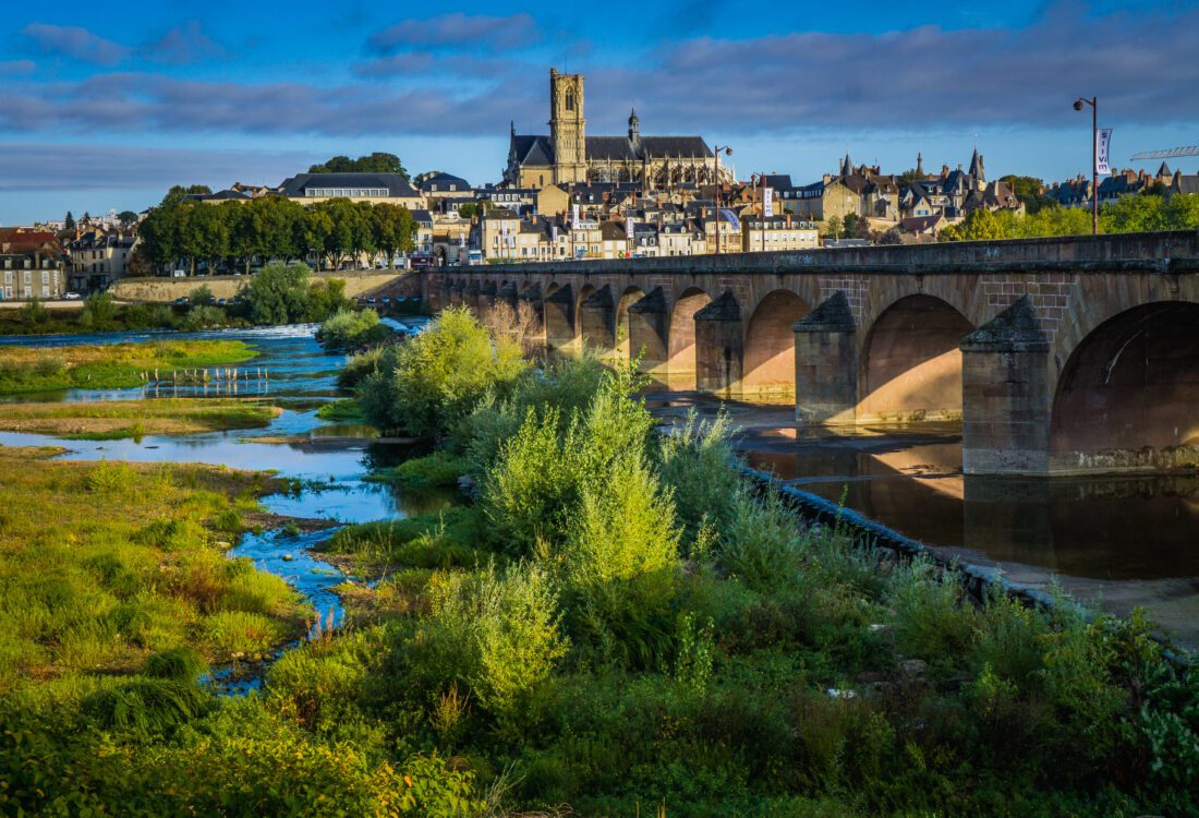 View on the gothic St Cyr Ste Juliette cathedral and the city of Nevers from the Loire River bridge
